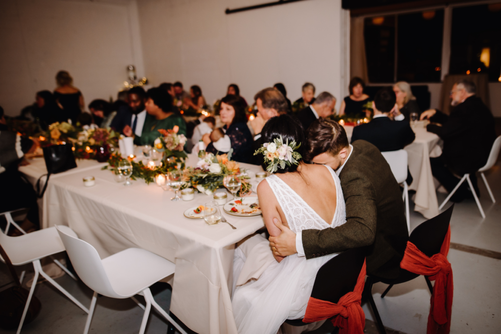 Bride and groom share a meal with guests