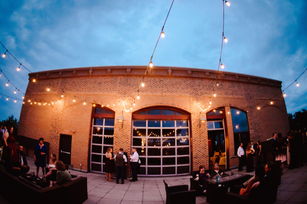 Wedding guests enjoy a rooftop lounge. 